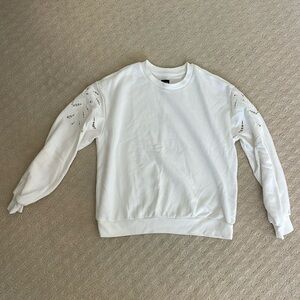 White pullover sweatshirt with embroidery detail on sleeves